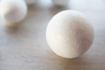 many small white balls toys new year symbol on red background , top view, there is a place for the text as   and substrate