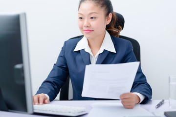 Young businesswoman working on computer.