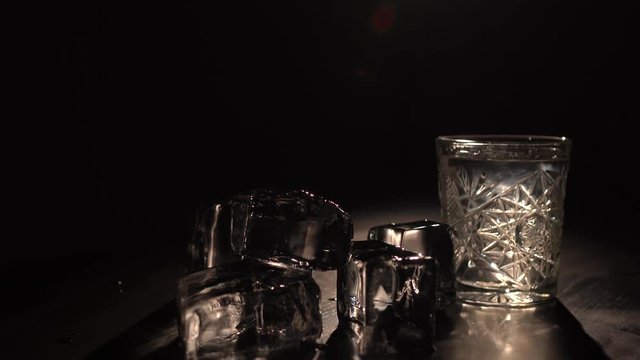 A glass of sambuka and a pyramide from ice