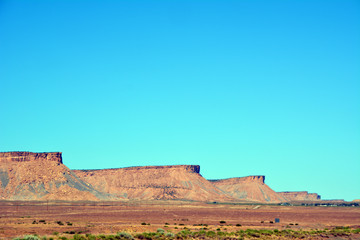 Utah Plateaus/Several plateaus in the Utah desert back by a bright blue sky.