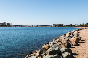 Fototapeta na wymiar Rocky shoreline on Mission Bay in San Diego, California.