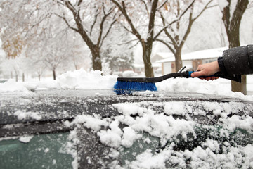 Transportation, winter  and vehicle concept - man cleaning snow
