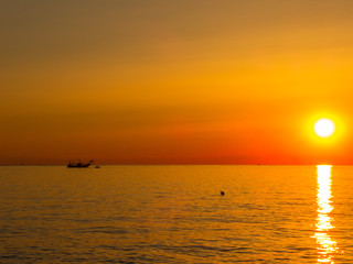 Fishing boats pull their nets at the sunrise. Adriatic cost. Emilia Romagna. Italy.