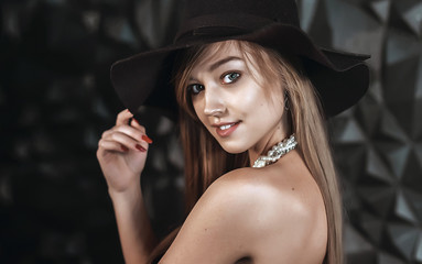 pretty girl in hat posing in Studio