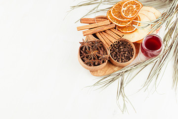 Christmas food background - mulled wine. Decorative border of  spices and drinks on white wood board. Top view. Cooking of  beverage.