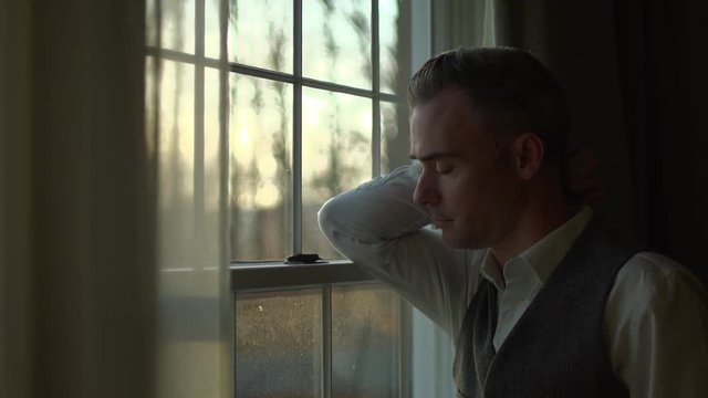 a man is terribly sad at home