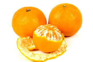 Three ripe orange tangerines on a white background, two whole and one cleared.