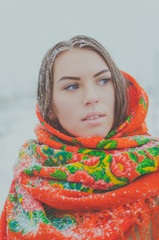 portrait of the Russian beauty with blue eyes in a scarf and coat.