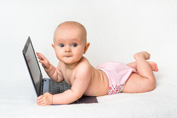 Cute baby with laptop computer