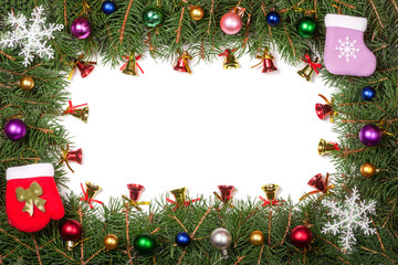 Christmas frame made of fir branches decorated with balls and bells isolated on white background