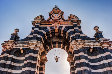 The arch Giuseppe Garibaldi built to honor the Spanish King Ferdinand I, Catania, Sicily. Triumphal arch built in 1768 - famous landmark of the city. - obrazy, fototapety, plakaty