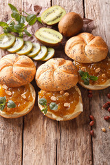 Sweet sandwiches with butter, kiwi jam and peanut close-up. Vertical