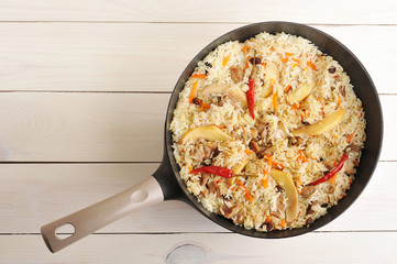 pan with pilaf with quince and chilli pepper