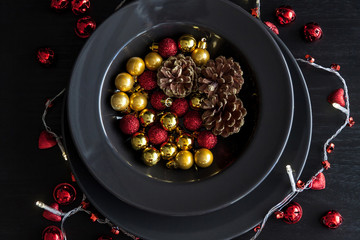 Christmas Decorations in the black plate on the dark background