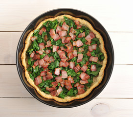quiche, spinach and bacon in the baking dish