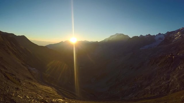 Timelapse sun setting in the Alps behind magnificent peaks viewed from Pordoi Pass in Italy