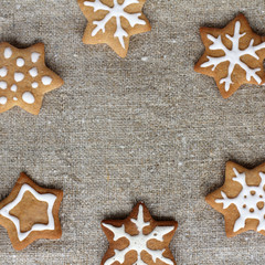 appetizing frame of delicious stars/ flat lay figure cookies on woven fabrics of flax top view 