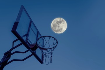 Basketball kit with clearboard, hoop, net and super full moon at night sky
Outdoor basketball...