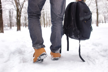 bearded man walking in a winter park