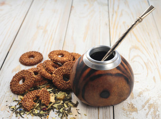 Yerba mate tea in a wooden calabash and cookies