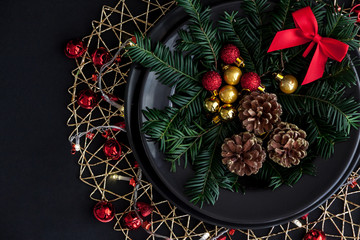 Christmas Decorations in the black plate on the dark background