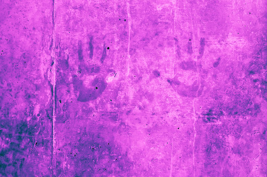 childrens hand impressions on a blue purple puplish pink or pinkish gray wall with scratches 