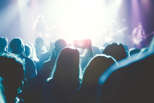 Female hands holding their smartphone and photographing rock con