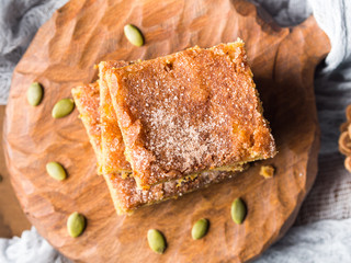 Apple and pumpkin spiced blondies on wooden board