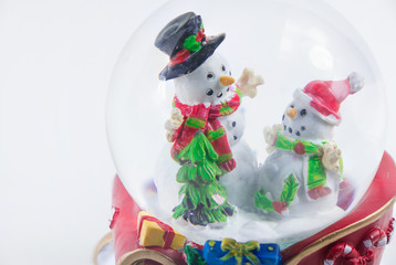 Close-up Christmas snow globe with snowman isolated on white background