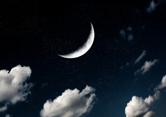 Fototapeta na wymiar The moon in the night sky in clouds