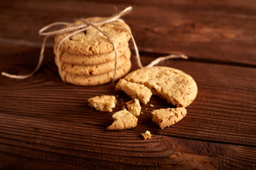 Homemade Chocolate cookies on wooden table. Pile of delicious chip cookies. Christmas cookies. Biscuits. Oat biscuits. Cereal biscuits with the addition of sesame, peanuts, sunflower and amaranth.