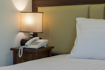 Closeup pillow on the bed with lamp in luxury hotel