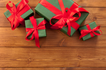 Presents in gift boxes on wood background