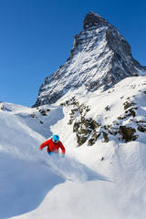 Skiing with amazing view of swiss famous mountains in beautiful