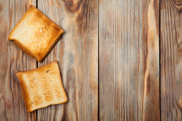 Fototapeta na wymiar Toast on a rustic wooden background