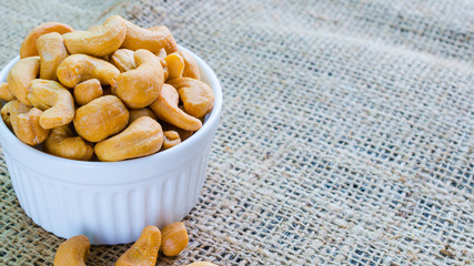cashew nuts salted and roasted in white bowl place on hemp
