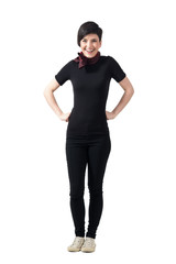 Fototapeta premium Cheerful happy woman looking at camera with hands on hips. Full body length portrait isolated over gray studio background.