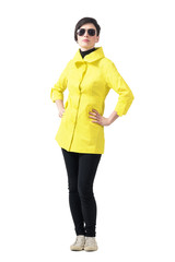 Confident proud woman in autumn clothes with sunglasses looking at camera. Full body length portrait isolated over gray studio background.