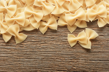 Dry butterfly pasta  on a wooden background. bow tie pasta.farfa