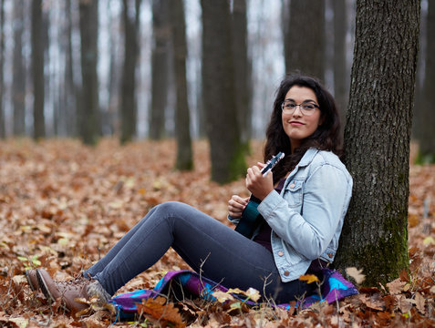 Latino girl playing ukulele