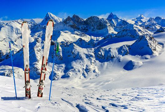 Ski equipment with amazing view of swiss famous mountains in beautiful winter snow. The matterhorn and the Dent d'Herens. In the background Castor and Pollux. View mrom Mt Fort