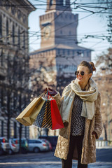 smiling tourist woman in Milan, Italy looking into distance