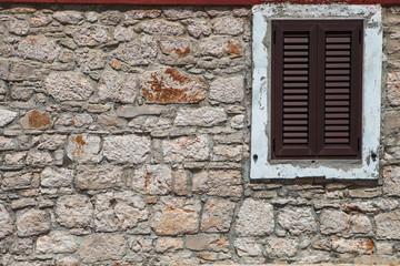 Fototapeta na wymiar Textured wall with brown shutters