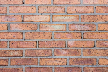 Grunge weathered red brick wall background.