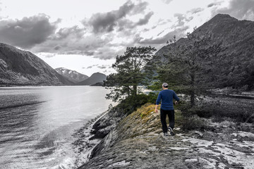 Fototapeta premium Young man is having fun hiking in Norway