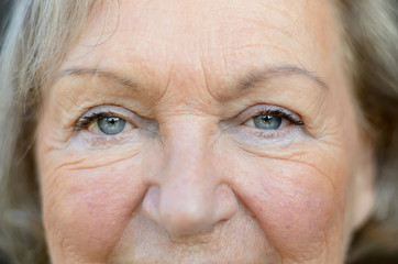 Naklejka premium Attractive senior woman with blue eyes