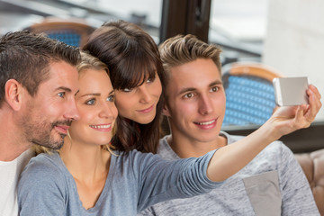 Obraz premium Group Of Young Adult Friends Taking Selfie