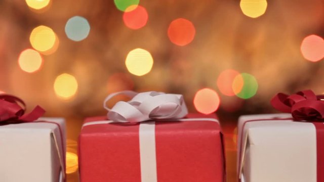 Slide in front of presents - gift boxes for christmas or other events against blurry lights
