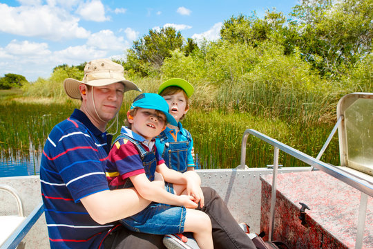 Two little kids boys and father making air boat tour in Everglades Park