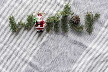 word winter laid out by fir tree branches, new year and christmas decorations on wool shawl
